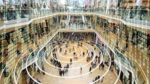 Radio waves on a mobile phone in a shopping mall with matrix style data layered on top.