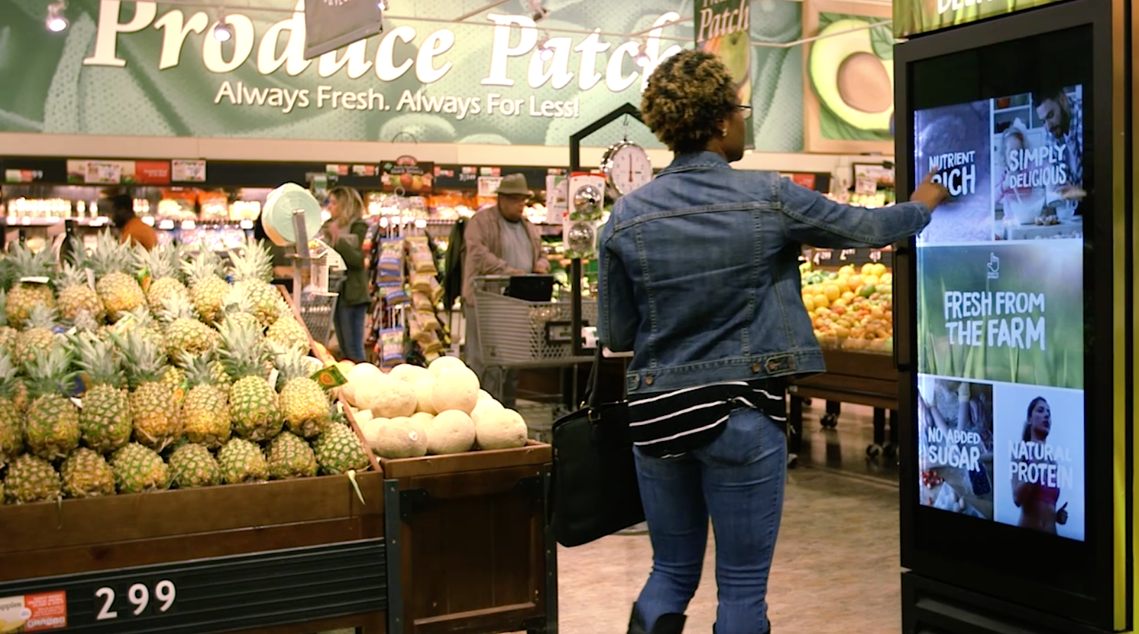 Woman interacting with kiosk